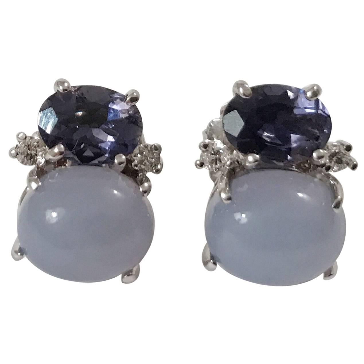 Mini 18kt white gold GUM DROP™ earrings with faceted Iolite (approximately 2 cts each), Cabochon Chalcedony (approximately 3 cts each), and 4 diamonds weighing ~ 0.20 cts.  
Specifications: Height: 5/8