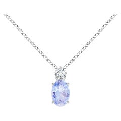 Colgante solitario de tanzanita oval natural con diamante en oro blanco de 18 quilates