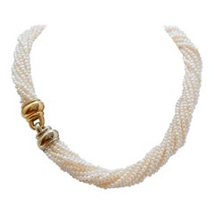 Perle, collana in oro giallo e bianco 18 carati.