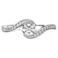 Round diamond moissanite spiral 14k gold ring.
