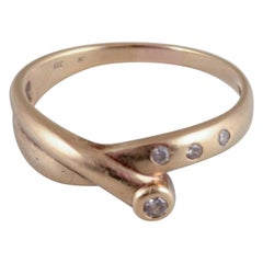 Danish goldsmith. 8-karat gold ring. Adorned with four brilliant-cut diamonds.