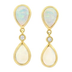 A Pair of Opal and Diamond Pear Shaped Stud Earrings in 18 Karat Yellow Gold