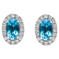 10K White Gold 5x3 MM Oval Blue Topaz and Diamond Halo Stud Earrings