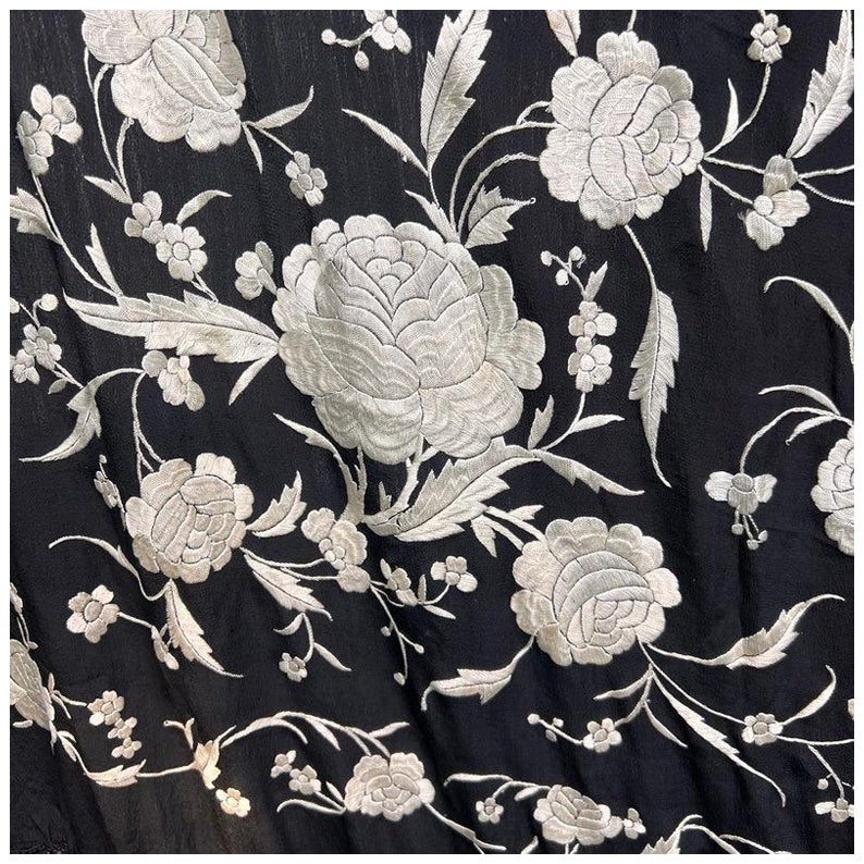 This exquisite antique Chinese piano shawl or panel dates from the first half of the 20th century. Featuring intricate hand-embroidered silk, it showcases traditional motifs and vibrant detailing, with elegant fringe adding an additional 16 inches
