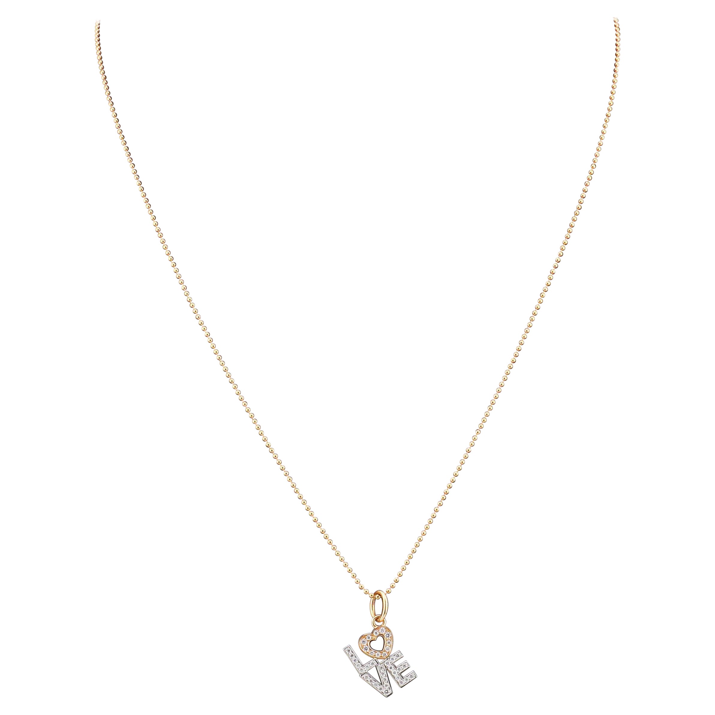 Presenting the Tiffany & Co. Diamond 18K White and Pink Gold Love Charm Pendant—an enchanting declaration of affection and timeless elegance. Crafted by the renowned luxury house, Tiffany & Co., this pendant embodies the spirit of love with