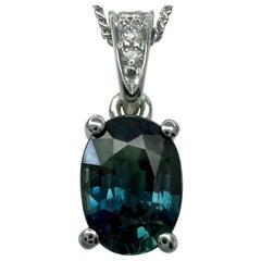 Colgante solitario en platino de zafiro azul verde vivo y diamante talla oval de 1,01 ct