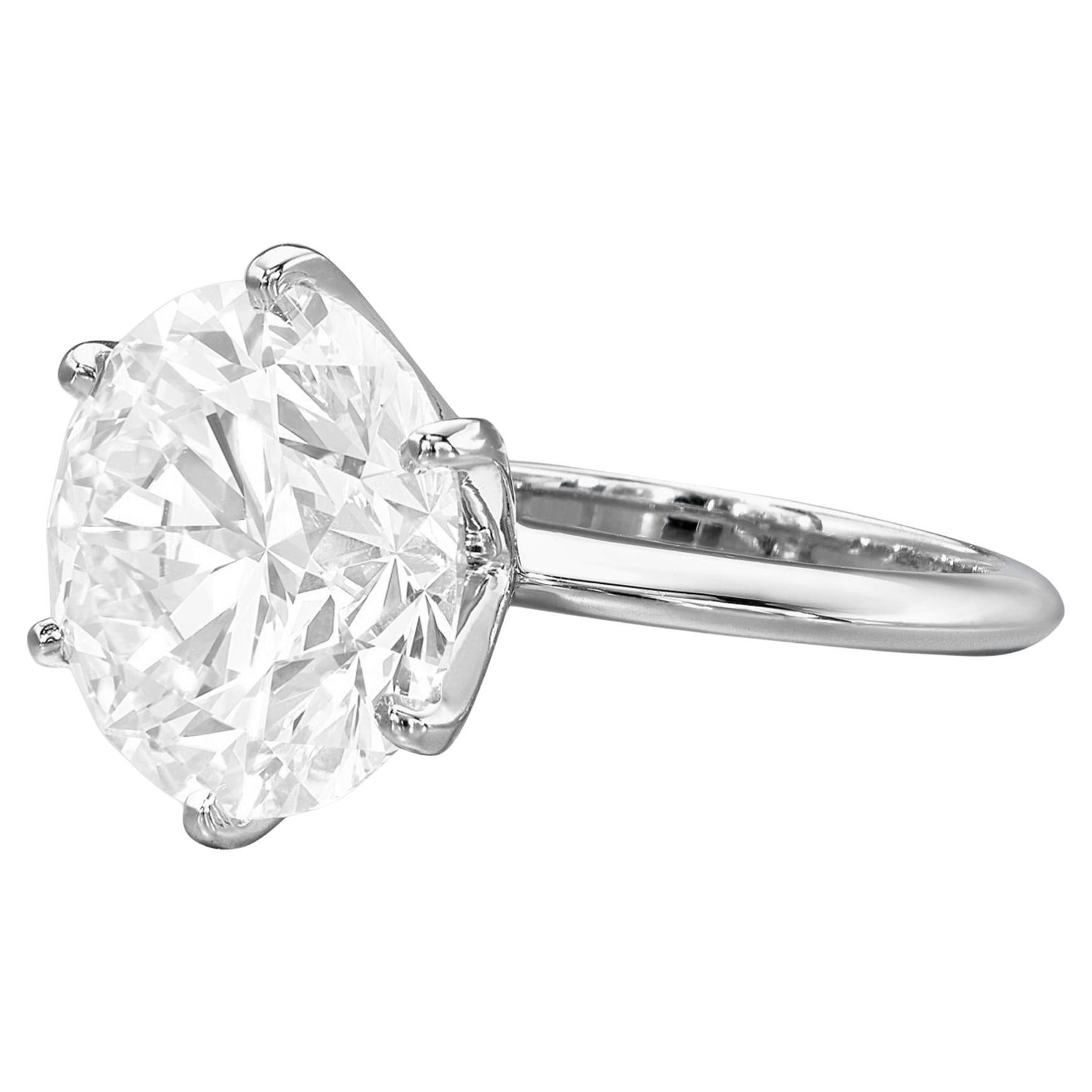 This stunning solitaire engagement ring features a remarkable 3.15 carat round cut diamond, set in an elegant platinum band. 

The diamond showcases a beautiful H color grade, exuding warmth and brilliance that enhances it's timeless appeal. With a