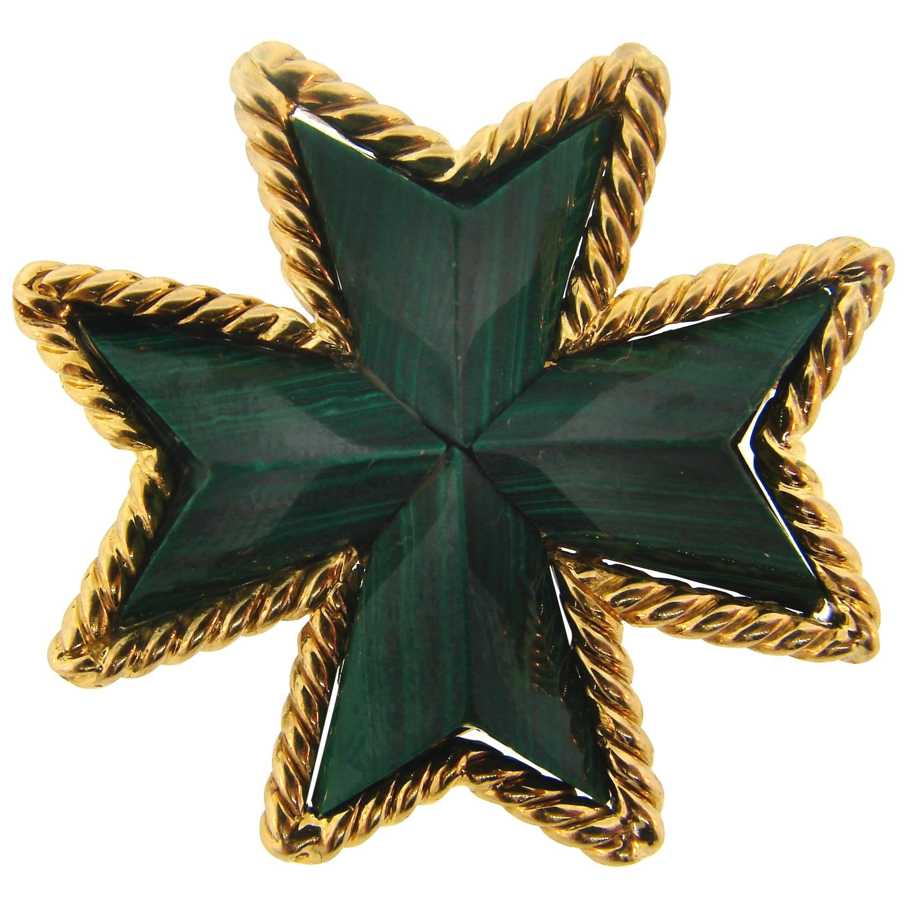 Colorful and elegant Maltese cross pin/pendant created by Tiffany & Co. in Italy. 
It is made of 18 karat (stamped) yellow gold and carved malachite. 
Measurements: 1-3/8 x 1-3/8 inches (3.4 x 3.4 centimeters).
Weight 19.2 grams. 
Stamped with