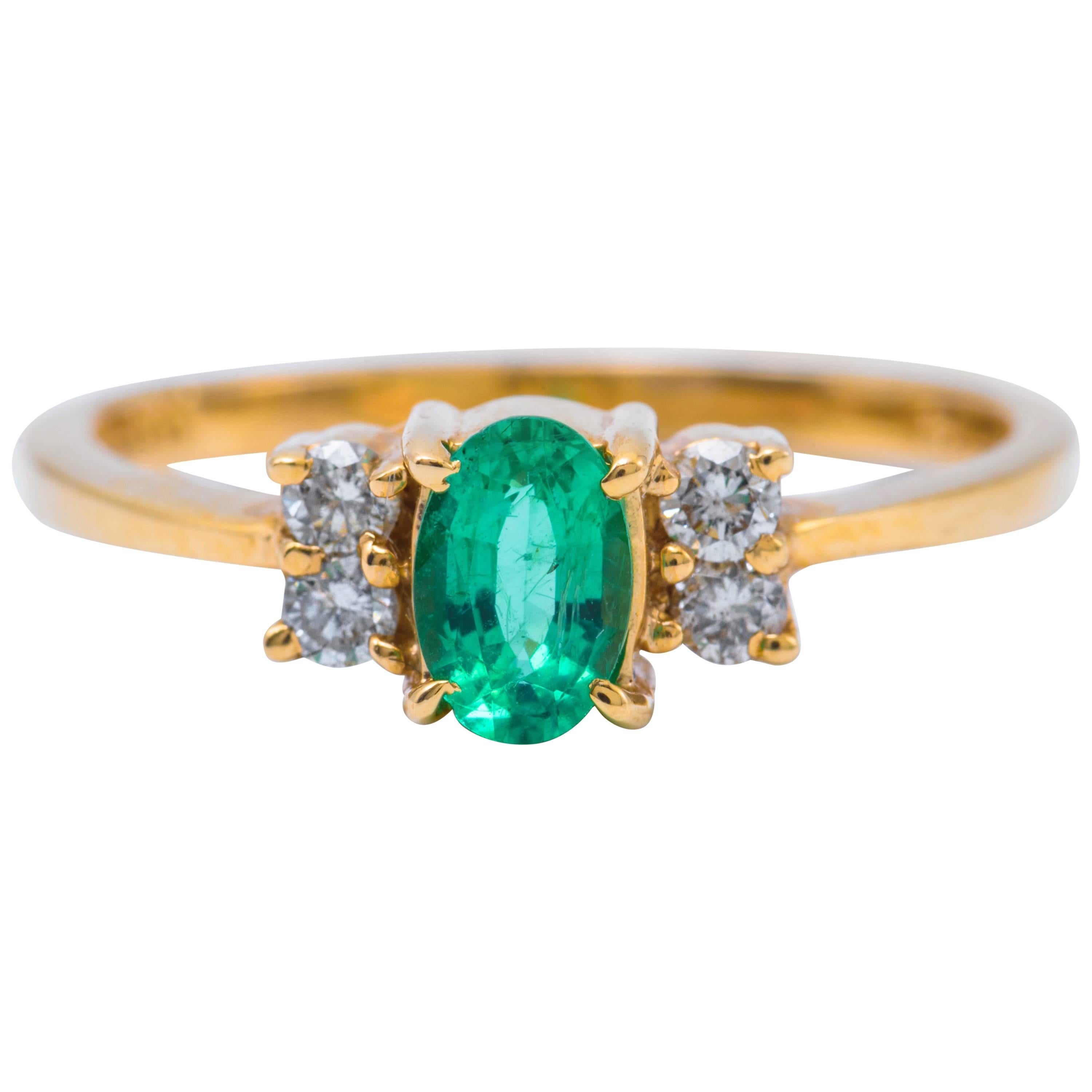 Oval Shaped Emerald and Diamond Engagement Ring in Yellow Gold