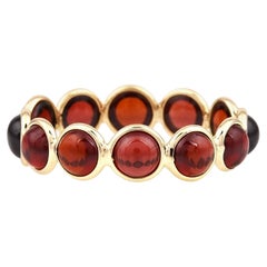 Fascia con cabochon rotondo di granato, oro giallo