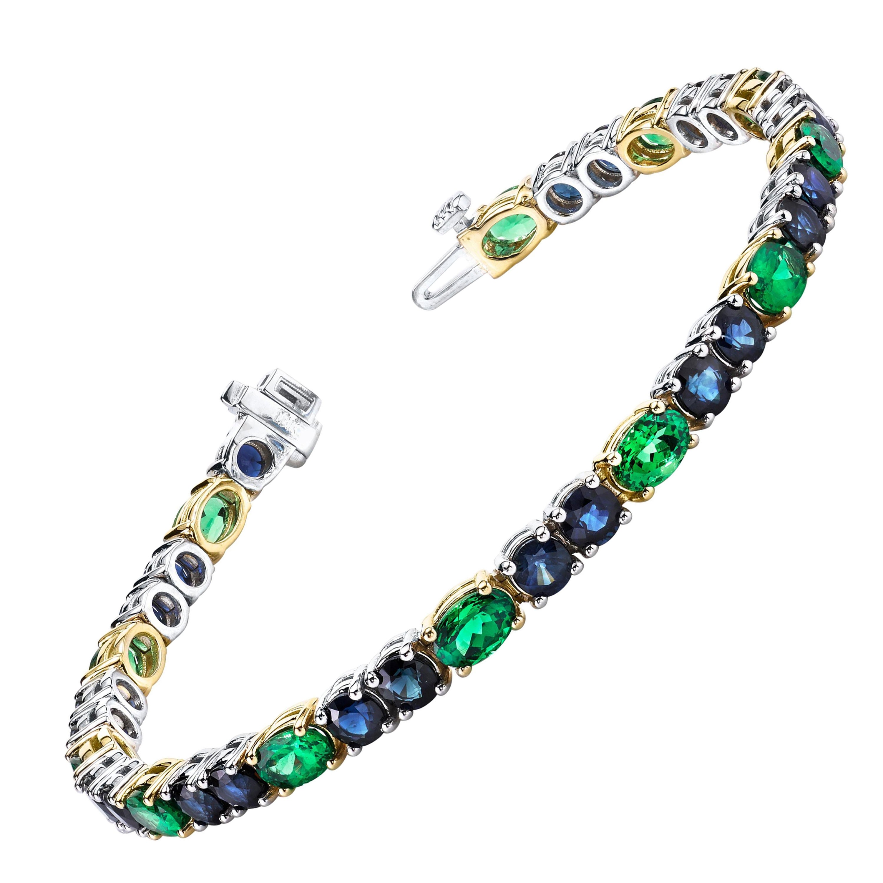 This gorgeous tennis bracelet features vivid deep blue sapphires paired with sparkling green tsavorite garnets! The richly colored blue sapphires have been set in bright, 18k white gold, while the vivid green tsavorites have been set in sparkling