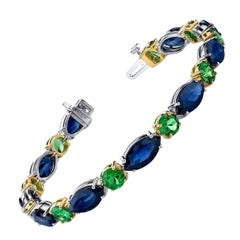 Tennisarmband aus Weiß- und Gelbgold mit blauem Saphir und Tsavorit-Granat