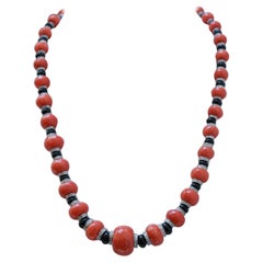 Coral, Onyx, Diamonds, 18 Kt White Gold, 14 Kt White Gold and 9 Kt White Gold.