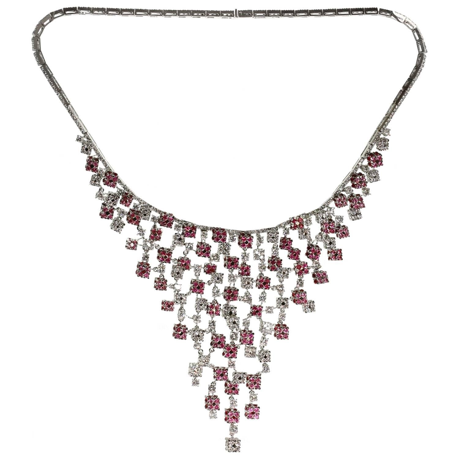 This exquisite bib necklace is crafted in 18k white gold and elegantly set with 590 diamonds of an estimated 19.0 - 20.0 carats and 408 faceted pink sapphires of an estimated 20.0 carats. Made in Italy circa 2000s. Measurements: 15.5