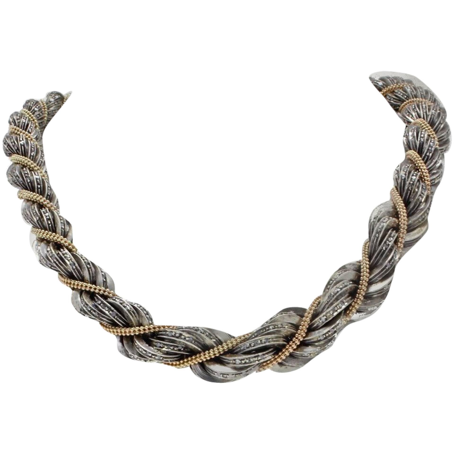 Choker necklace in 14 Kt gold and silver with a spiral design adorned with diamonds.
this necklace was made completely by hand with a technique unknown today without the help of any machinery, it is a unique and rare necklace, for those who will