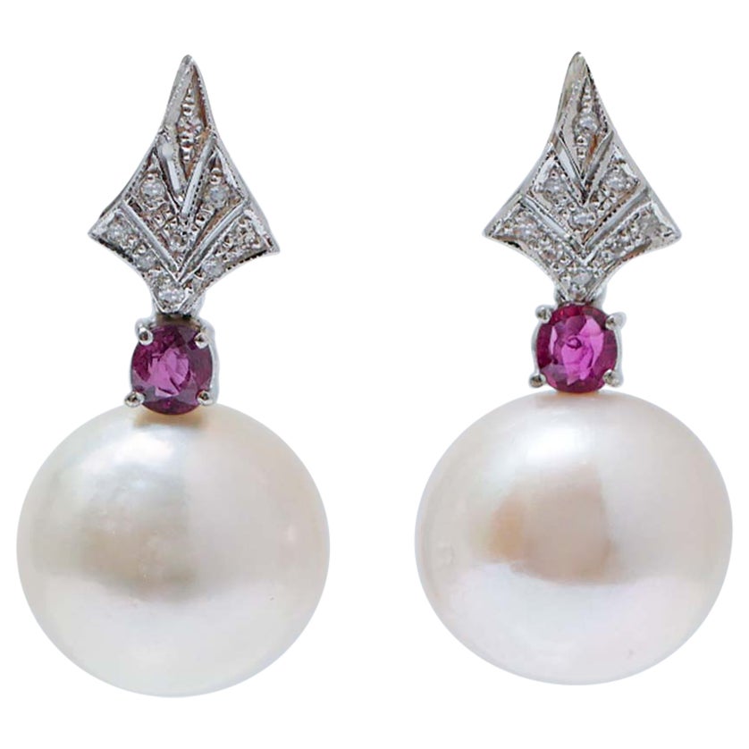 14 Mm White Pearls, Rubies, Diamonds, Platinum Earrings.