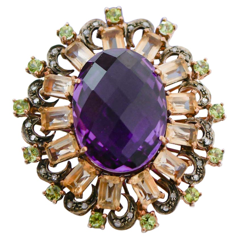 Amatista, topacio, peridotos, diamantes, anillo de oro rosa y plata.