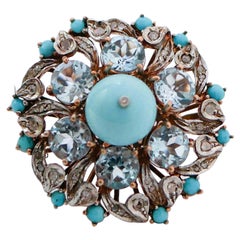 Anello in turchese, magnesite, diamanti, topazio, oro rosa 14 carati e argento.