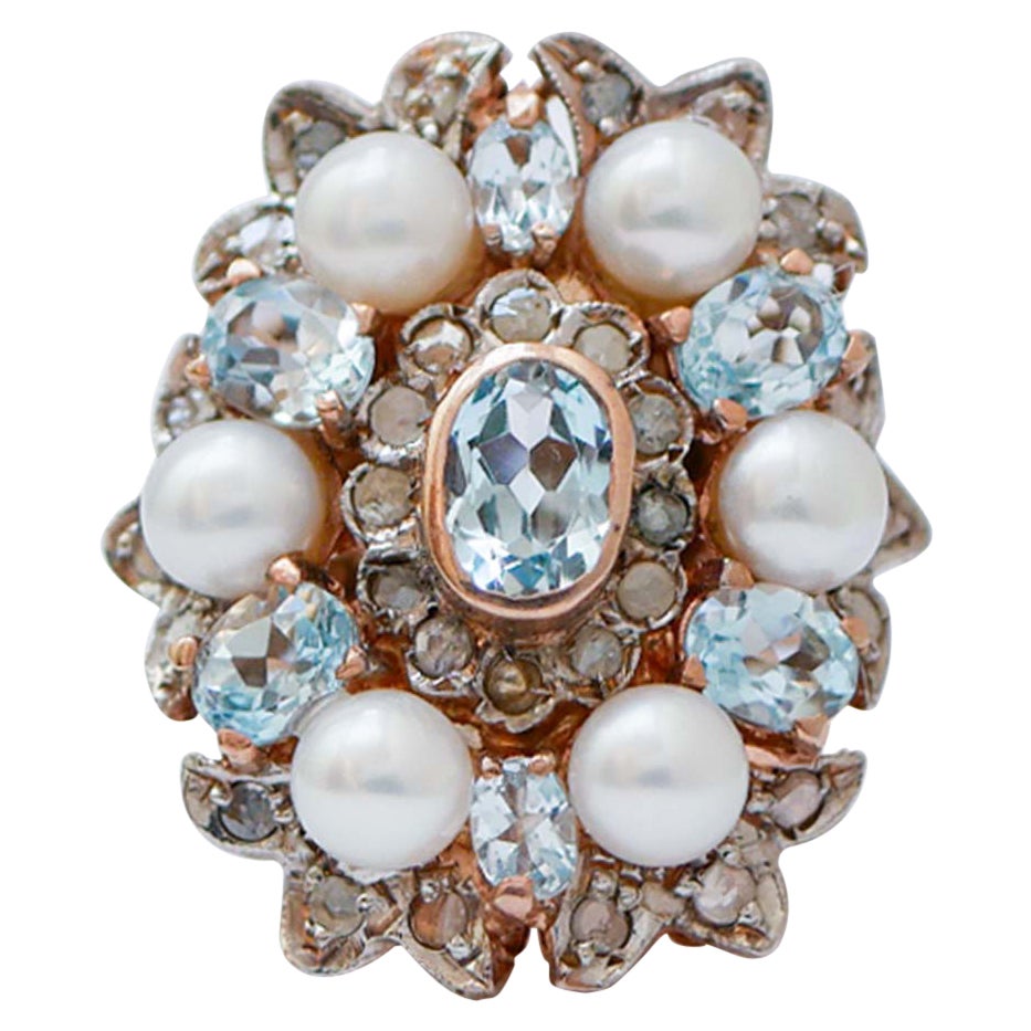 Topacio color aguamarina, diamantes, perlas, anillo de oro rosa y plata.