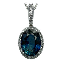 1.23ct Vivid Blue Oval Cut Sapphire And Diamond 14k White Gold Halo Pendant