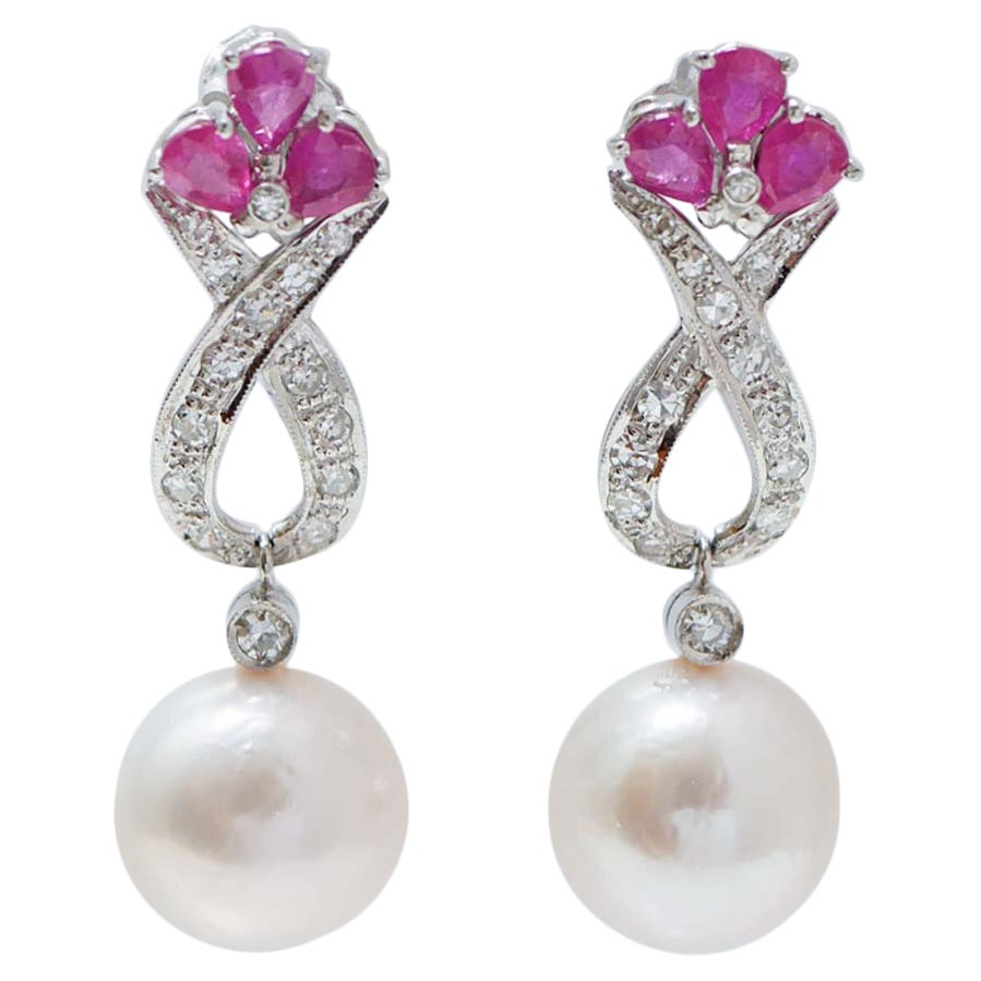 14 Mm White Pearls, Rubies, Diamonds, Platinum Earrings.