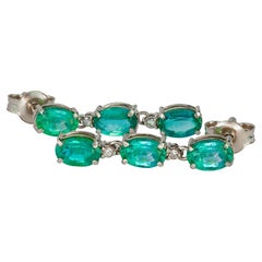 Emerald earrings studs in 14k gold.