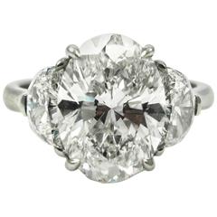 GIA Certified 4.03 Carat Oval Diamond and Half Moon Platinum Three Stone Ring