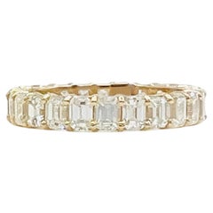White Diamond Emerald Cut Eternity Band Ring in 14K Yellow Gold
