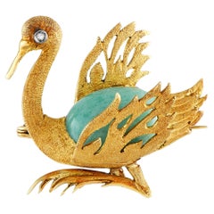 Broche de oro amarillo de 18 quilates con diamantes y cisne de turquesa