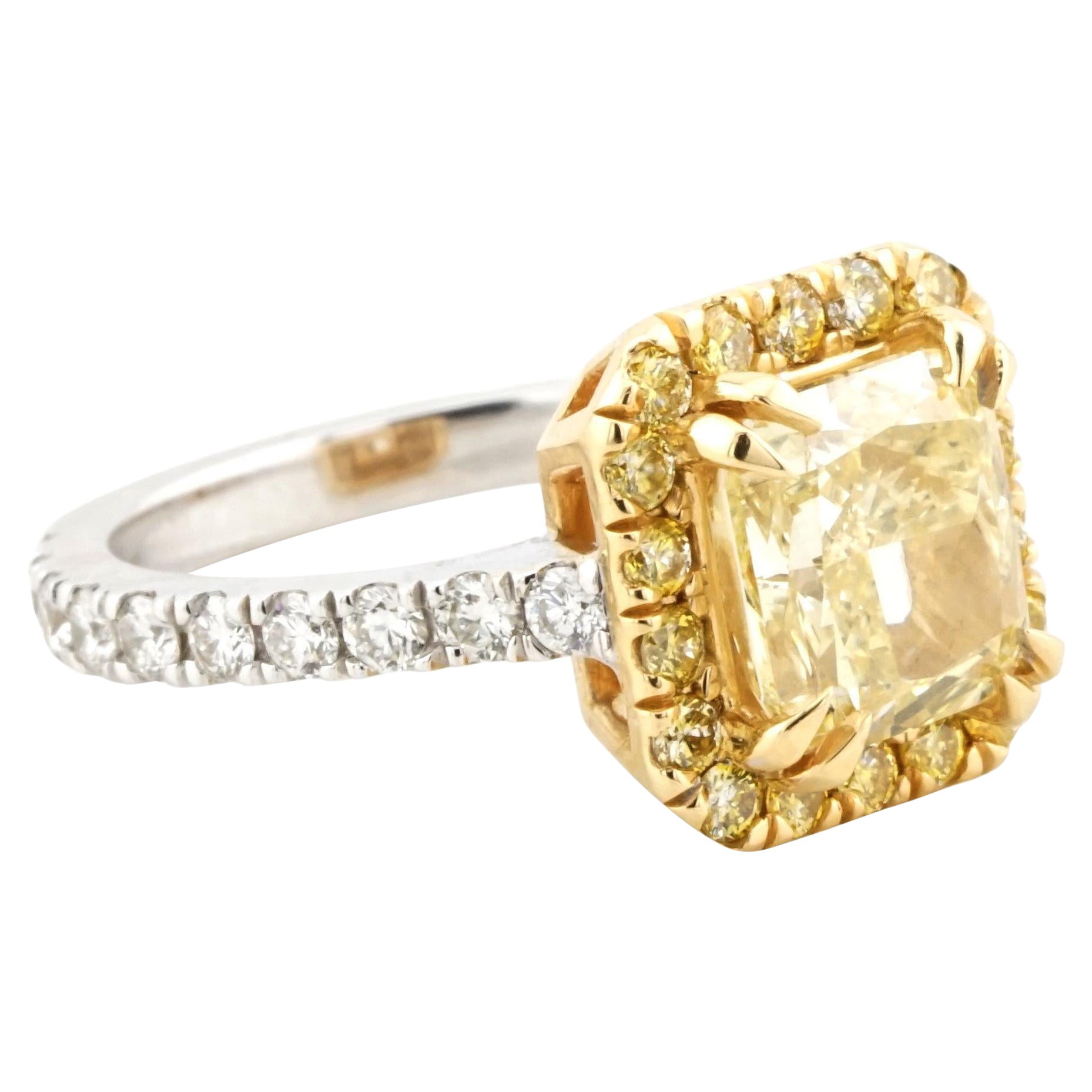 This creation by Cecile Blake combines 18K white and yellow gold to showcase a 2.05-carat fancy yellow diamond, GIA-certified for its natural origin and even color distribution. The modified rectangular brilliant-cut diamond, graded SI1 in clarity,