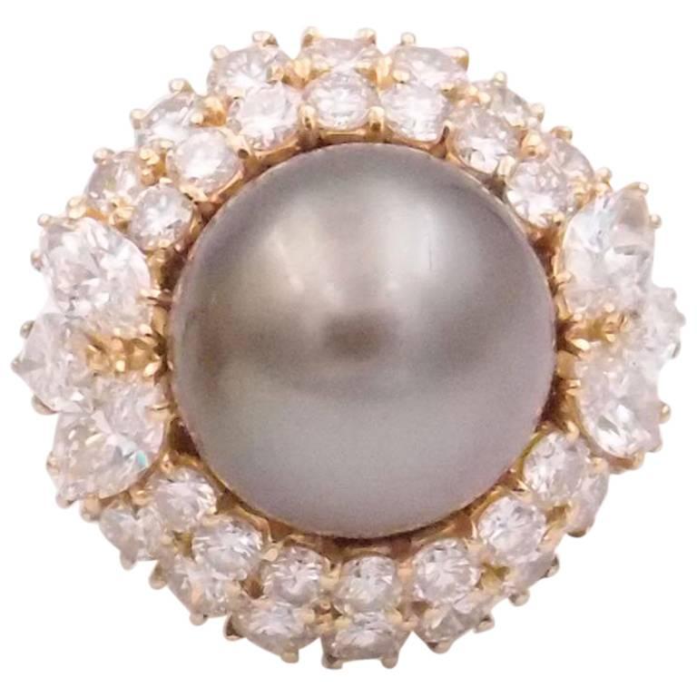 Harry Winston 18K yellow gold Tahitian pearl and 4 ct tw diamond ring includes box and paperwork
1 Natural Tahitian pearl 13 mm 
6 marquise diamonds 1.70 cts
28 round diamonds 2.30 cts

(Earrings are sold separately)