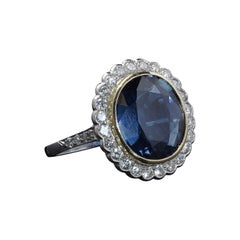 Certified Platinum Cluster Ring with Unheated 6ct. Blue Sapphire and diamonds