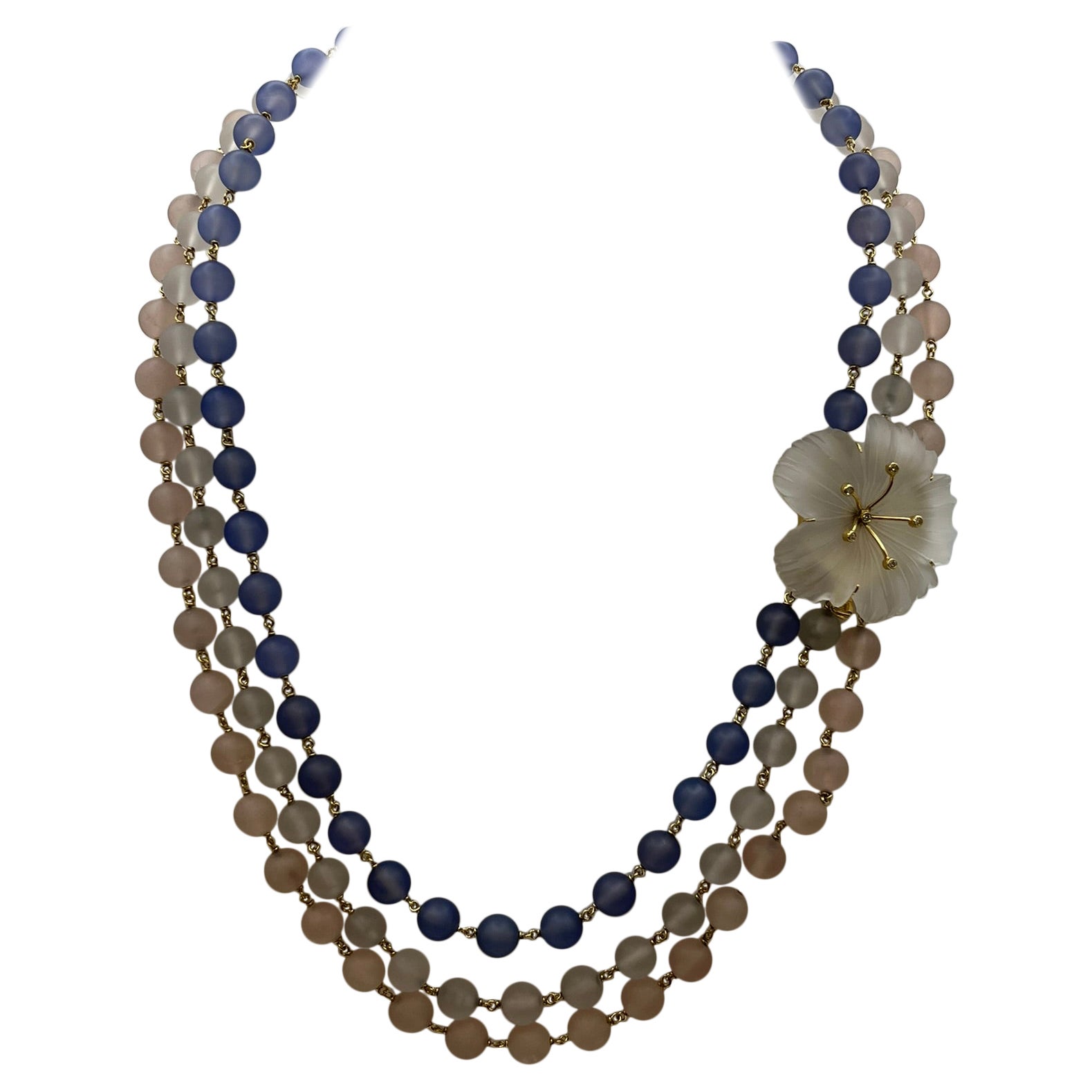 Multi-strand necklace with flower clasp.