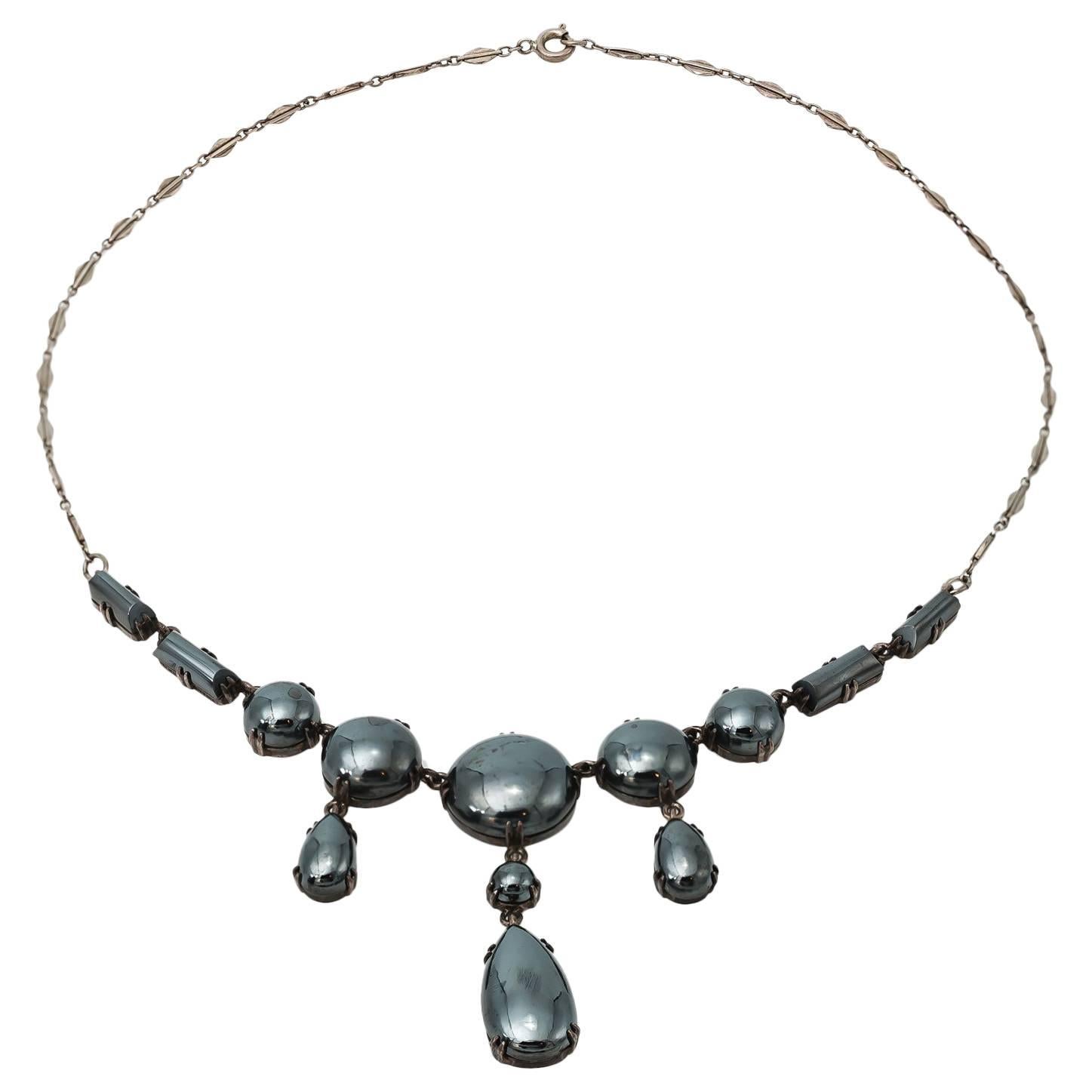 Smooth and shiny, these round hematites glisten and glow while set in a gorgeous sterling silver necklace. A 1930's German design this tapered necklace is a substantial antique that's elegant and sophisticated. Reminiscent of the Art Deco Era and