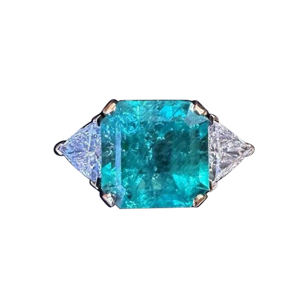 GIA Colombian 7.72 carat Emerald in Three Stone Ring in 18k Yellow Gold