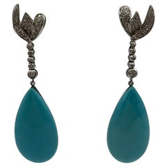 Orecchini in oro bianco 18 kt. con pendente di turchese