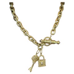 18 Karat Yellow Gold Diamond Toggle Necklace with Key and Lock Charms 79.4 Grams