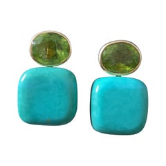 Orecchini a perno in oro giallo massiccio 14k con peridoto ovale sfaccettato a forma di cuscino di turchese