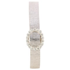 Montre secrète ANDRE COL en or blanc et diamants