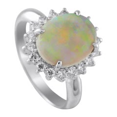 Anello in platino con diamante e opale da 0.40 carati