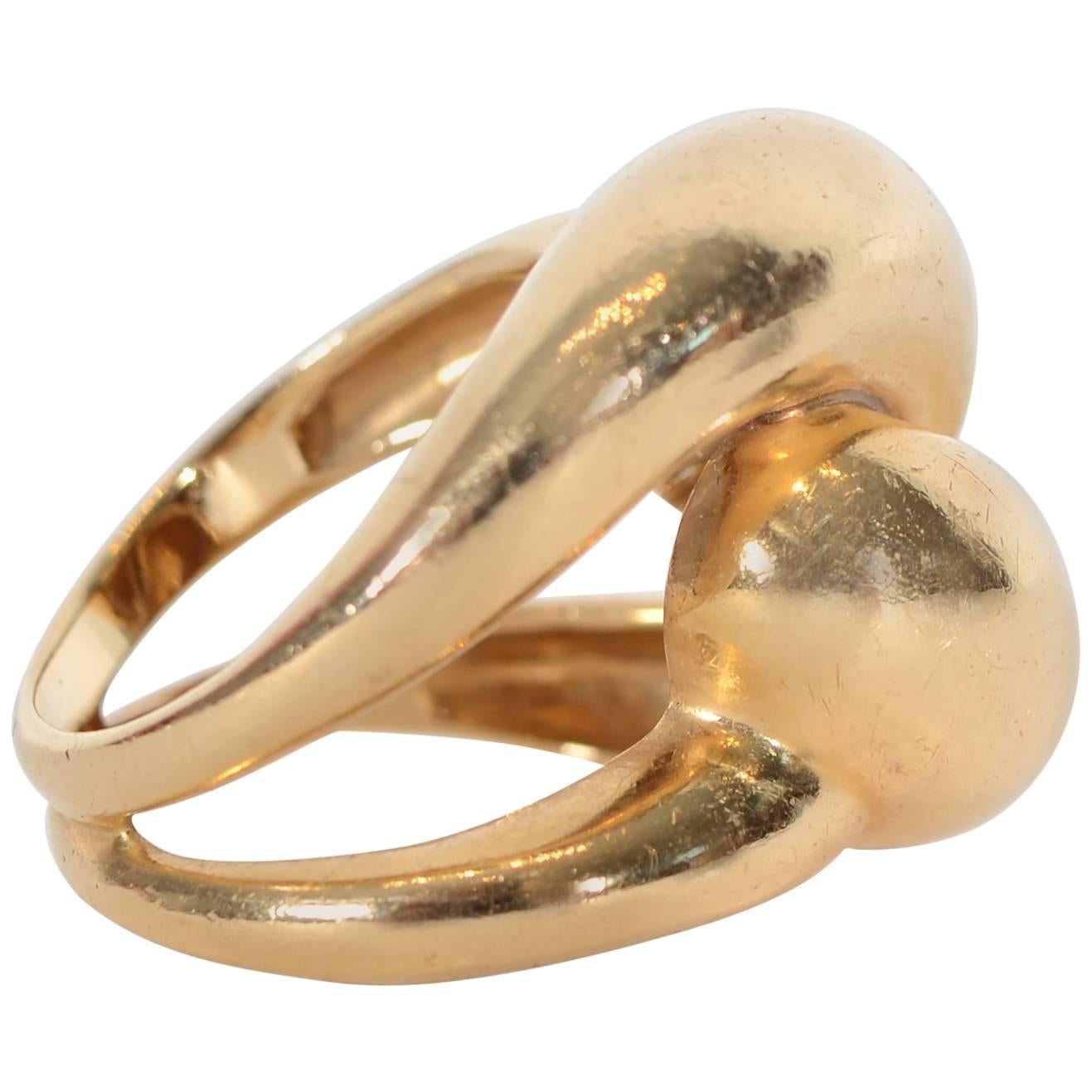 Bulbous knot ring of 14 karat gold suitable for a man or woman. The ring is size 6 . It can easily be sized up or down by adapting the two bands that join as the shank. 