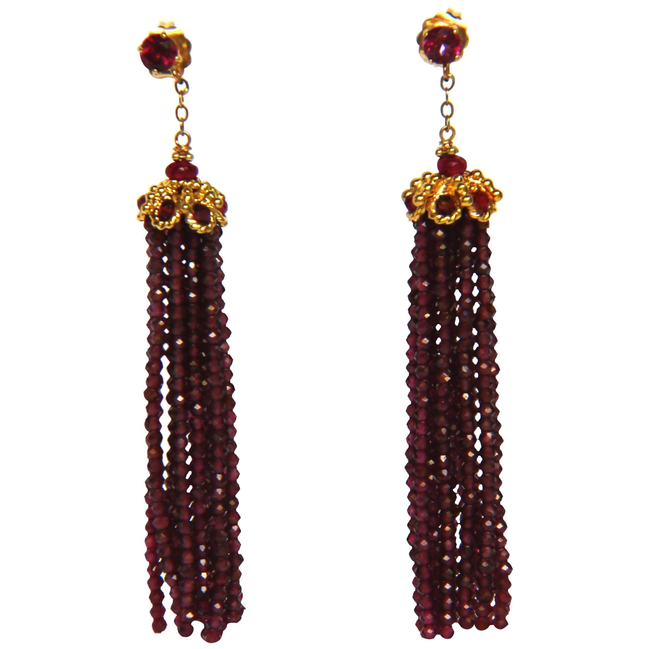 These unique earrings are composed with the finest 1 mm faceted amethyst beaded tassels with 14k yellow gold cup and stud to complete the look. The tassels flow out of a 14 K yellow gold cup, with amethyst and ruby beads connected to a fine 14 k