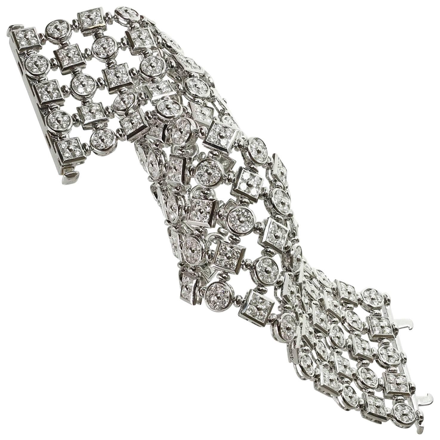 This fabulous flexible wide bracelet features four rows of round and square links set with round brilliant-cut diamonds of an estimated 24.0 carats. This magnificent 18k white gold bracelet feels and sparkles like a dream! Made in Italy circa 2000s.