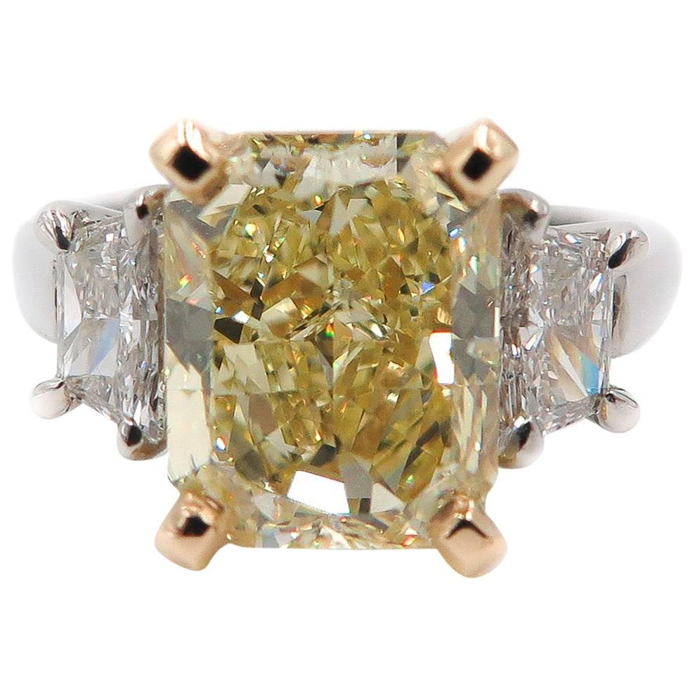 This alluring ring features a classic yet stunning design showcasing the stunning 4.04 carat natural fancy yellow radiant cut diamond cut that is prong set in a yellow gold crown. This gorgeous diamond is GIA certified as Natural Fancy Yellow in