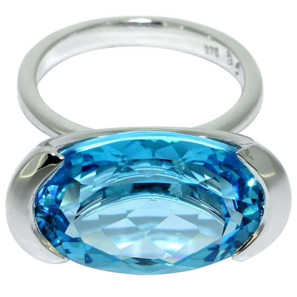 The setting of this elegant ring embraces the stone, with the sides left open to allow abundant light into the stone. It is crafted in our Sydney workshop, in 9 karat white gold and set with an approximately 15 carat natural Swiss Blue Topaz gem.