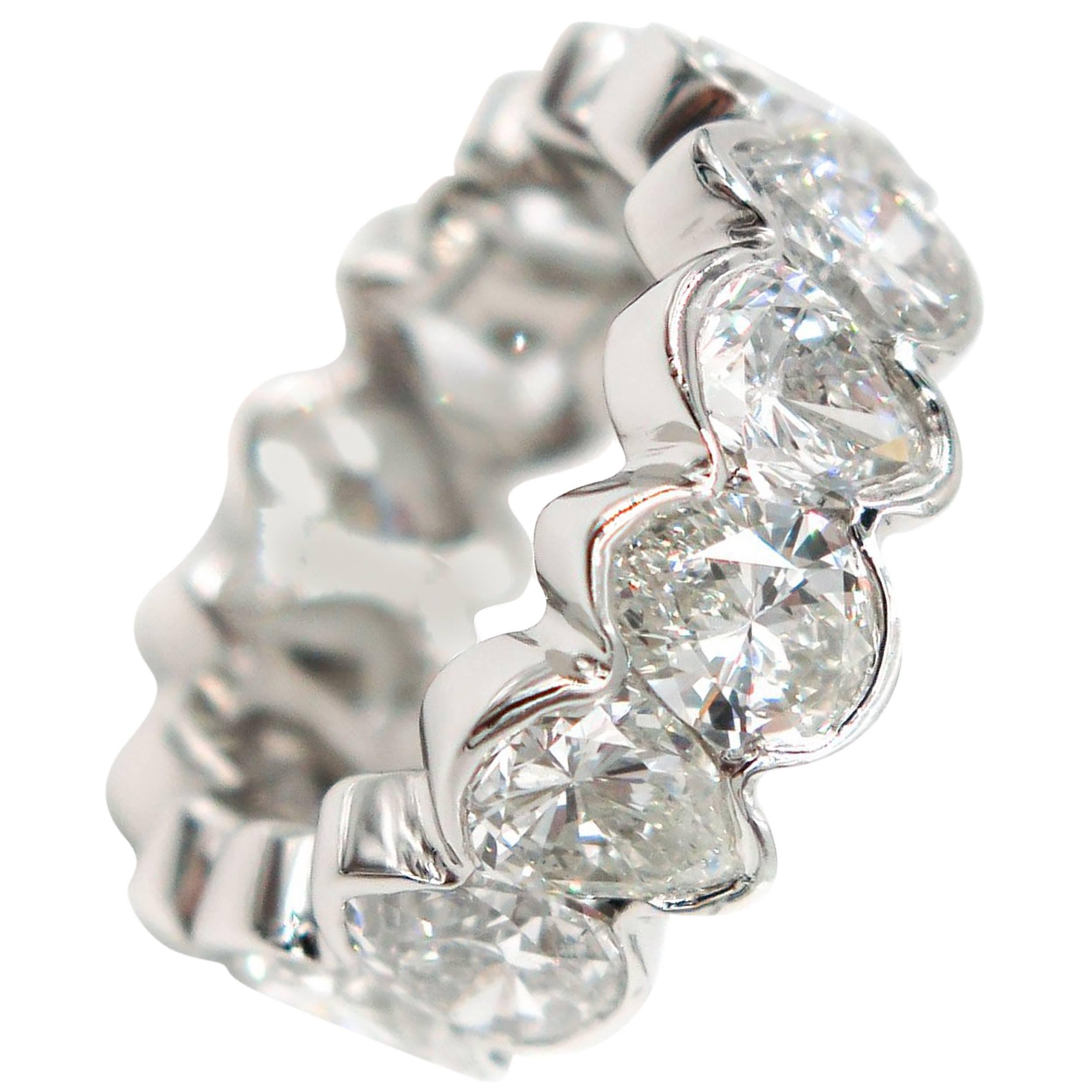 This beautiful diamond eternity band features 16 hand picked matching pear shaped diamonds weighing approximately 8.32 carats. G-H color and VS2/SI1 clarity.
This ring is handcrafted in platinum and provides a mosaic of light and color that twinkles