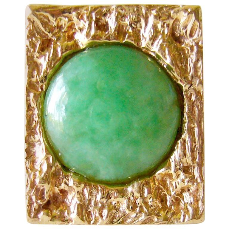 Heavy, 14k gold ring with jade cabochon, circa 1960's.  Ring is a finger size 5.75 to 6 and could easily be resized if need be.  An unconventional alternate to a modern day wedding or engagement ring. Suitable for a man or woman.  Signed 14k and in