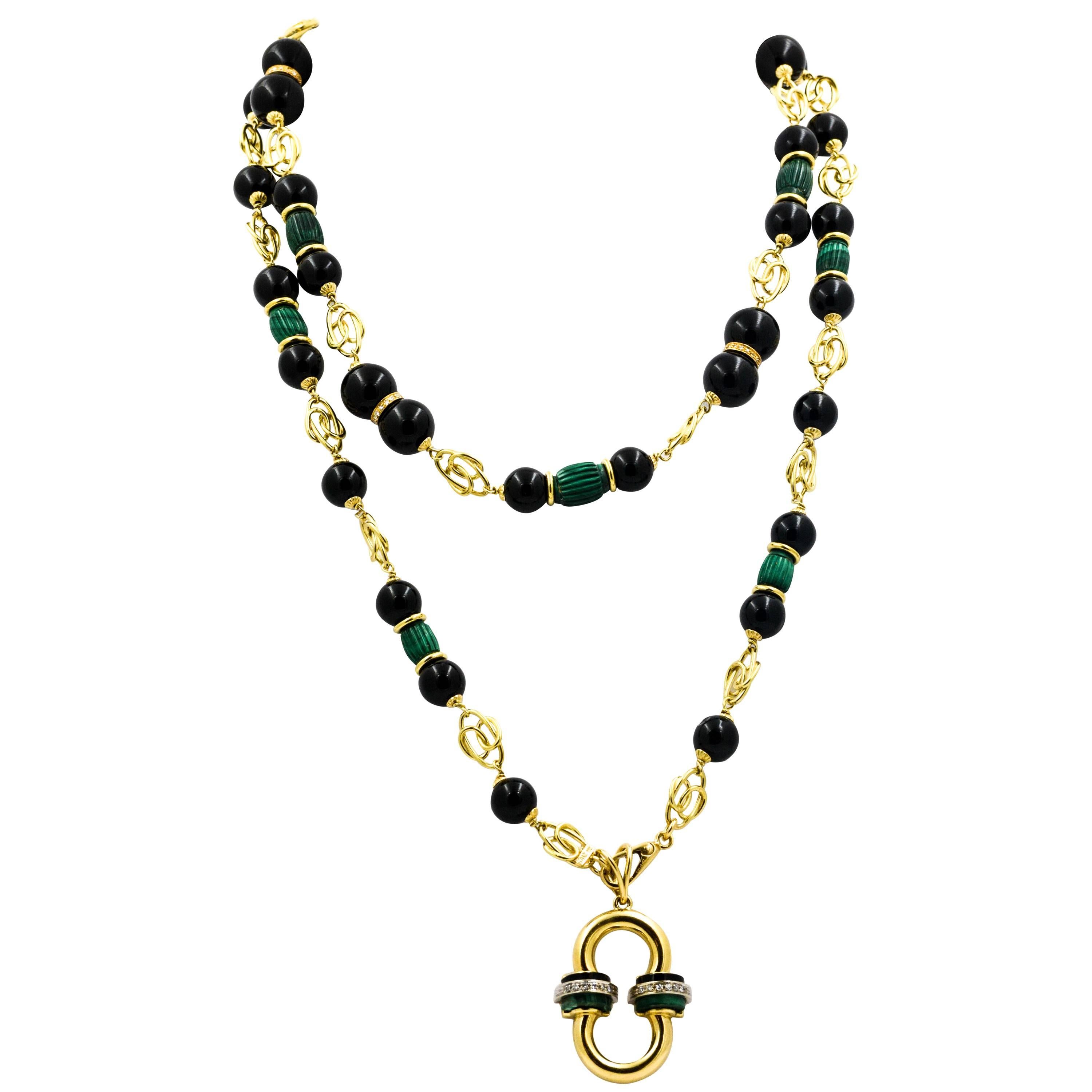 A dramatic gold pendant of diamond roundels hang from this amazing 18kt Yellow gold necklace. The necklace and pendant feature vibrant green malachite accented by beautifully contrasting onyx.  Both the malachite and onyx are accented by diamond