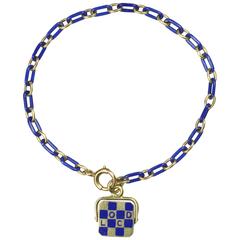 Art Deco Spinning Blue Enamel and Gold Good Luck Charm Bracelet, circa 1930