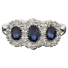 Oval Blue Sapphire Diamond White Gold Three-Stone Halo Engagement Ring